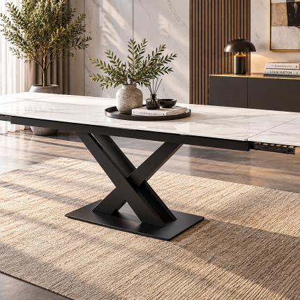 White marble-effect ceramic extending dining table with black X-frame pedestal base shown fully extended