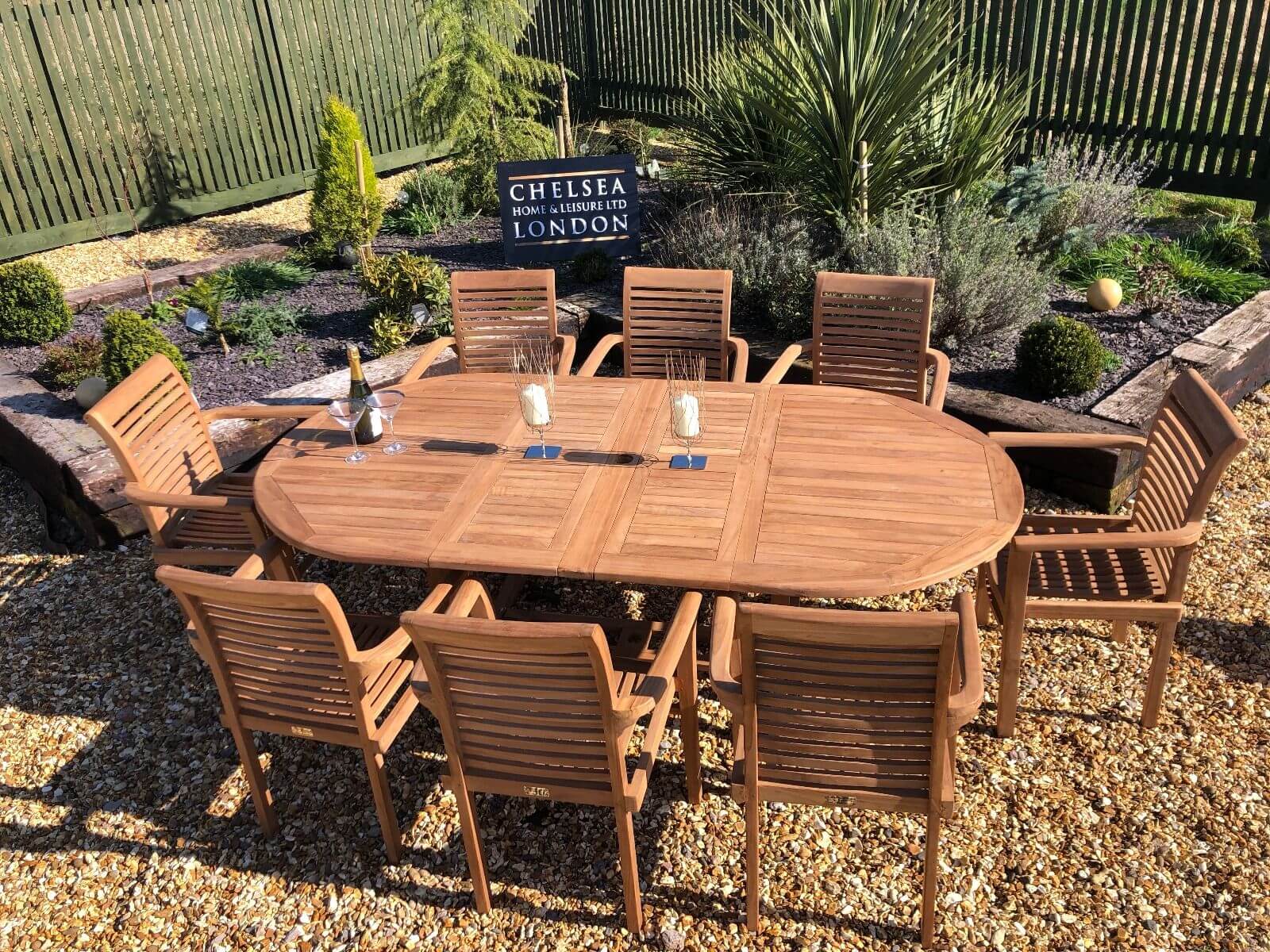 luxury extending teak table with 8 stacking teak chairs - chelsea home